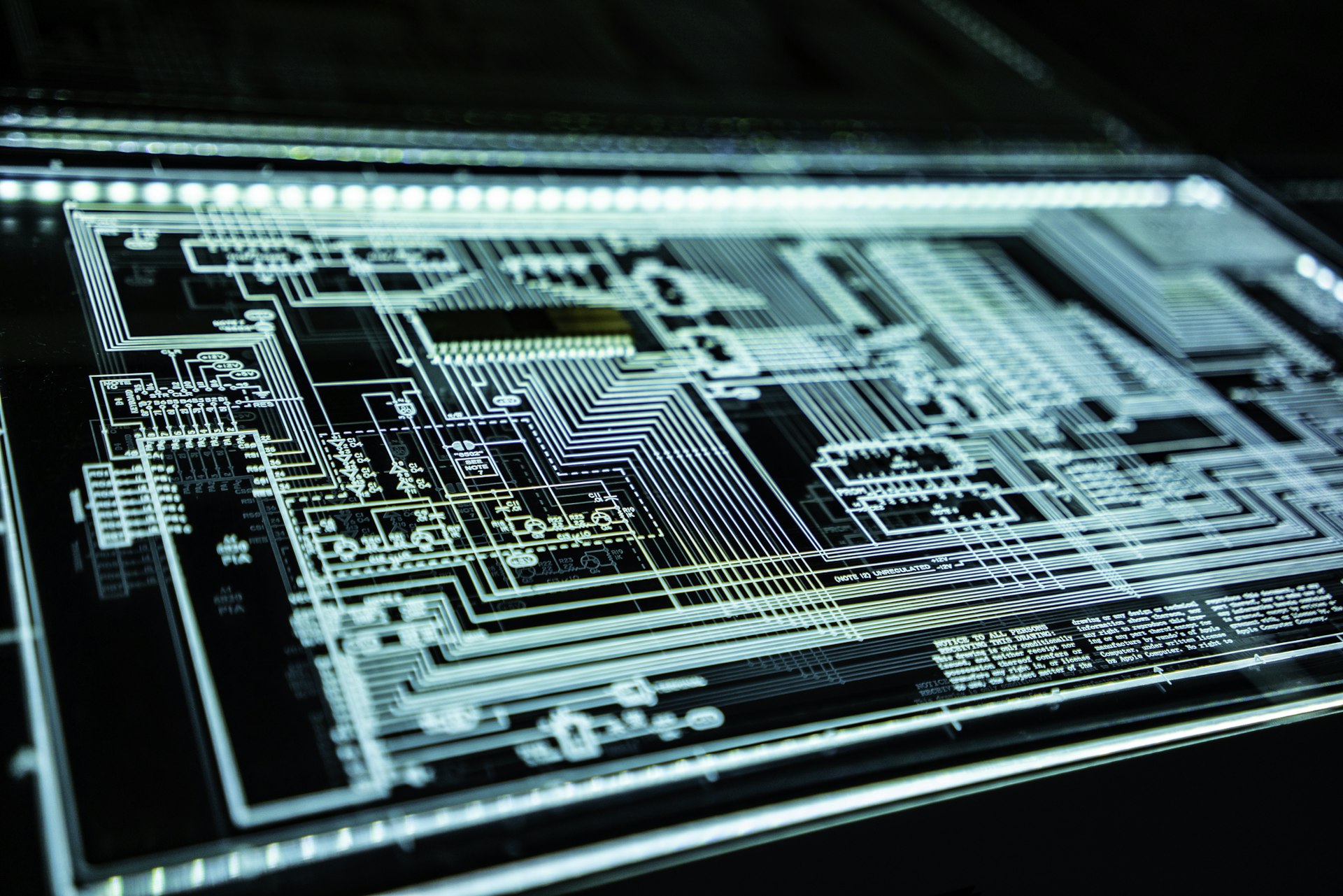 Backlit electronic circuit-board schematic on a light table